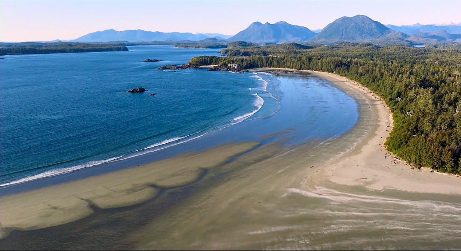 Aerial view of Chesterman Beach’s curved shoreline and surrounding coastal forest