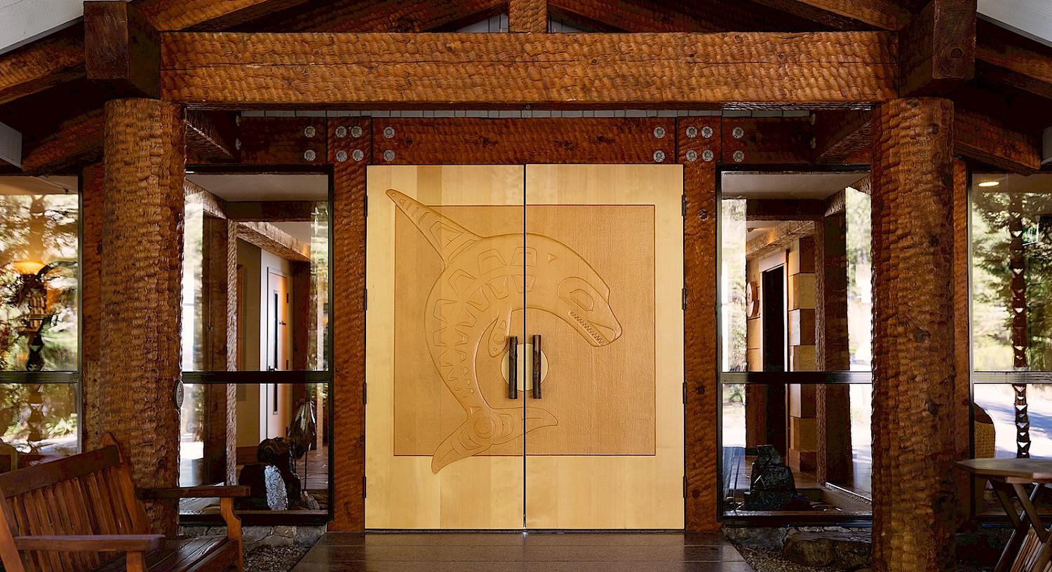 Double doors at the Wickaninnish Inn featuring a carved orca design by Henry Nolla