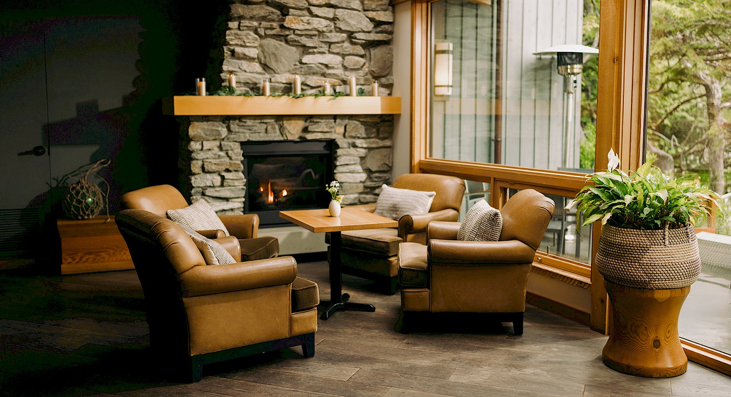 cozy armchairs gathered around a stone fireplace