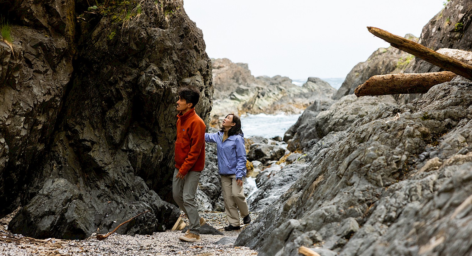 Two people exploring a rocky intertidal zone in Ucluelet