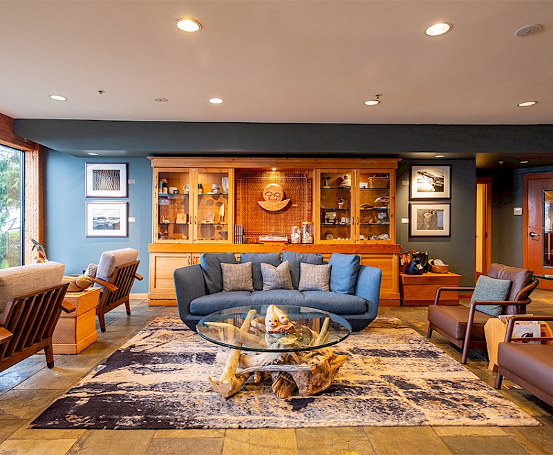 Seating area with blue couch and brown leather chairs in the Pointe Building lobby