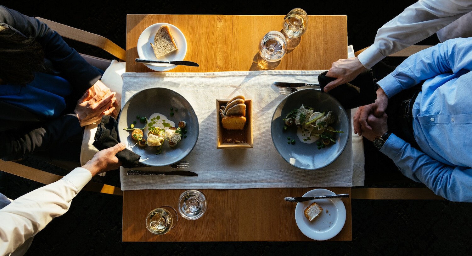 Aerial shot of a table set for an early dinner for two at The Pointe Restaurant. The ingredients are fresh and artistically plated.