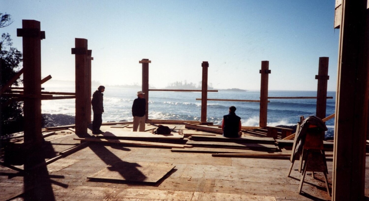 Charles sits on the ground of The Pointe Restaurant while it is still under construction. There is no roof or windows, just a floor and pillars that would soon frame the incredible views found from The Pointe.